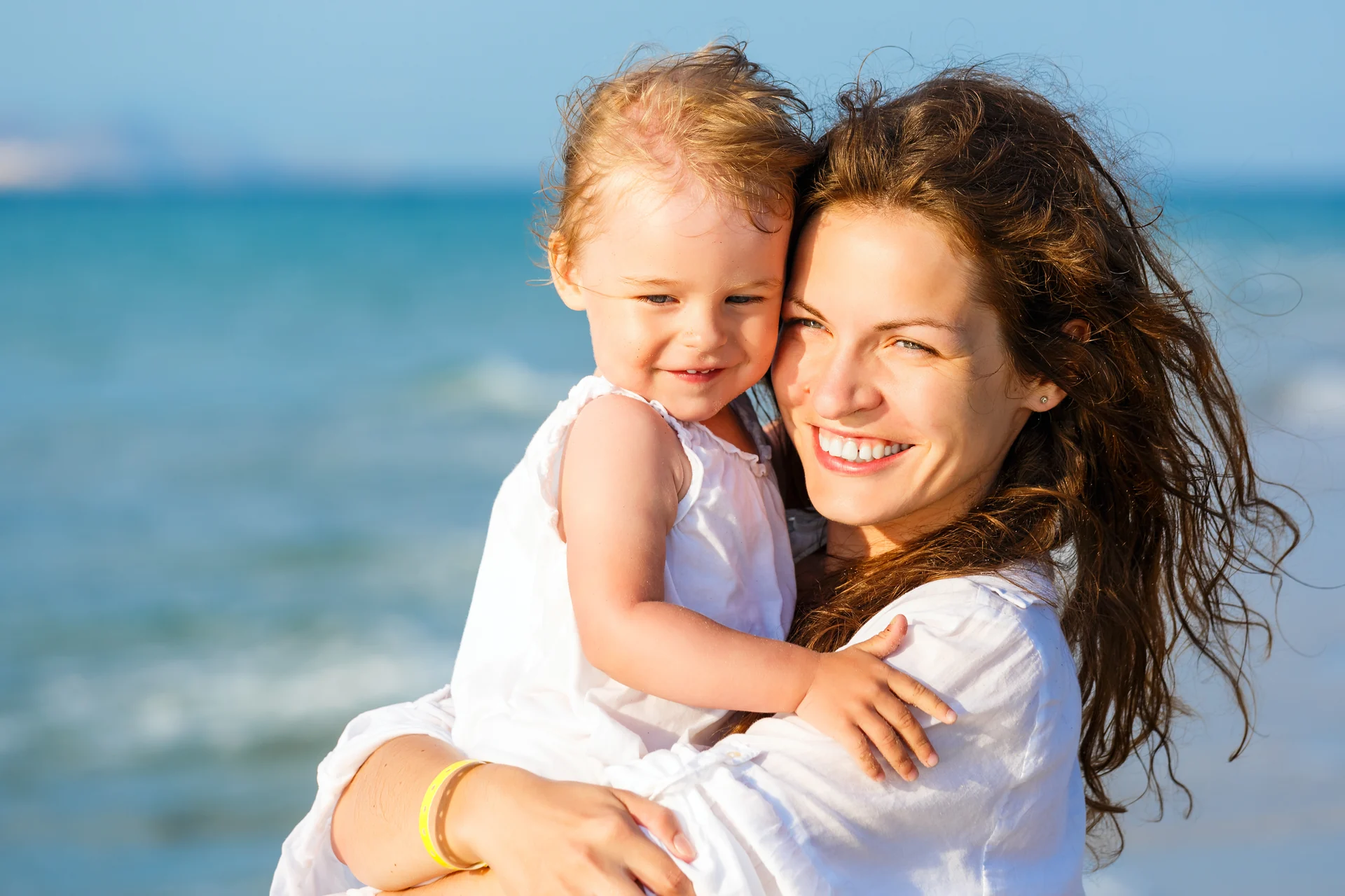 A parent and child together by the sea