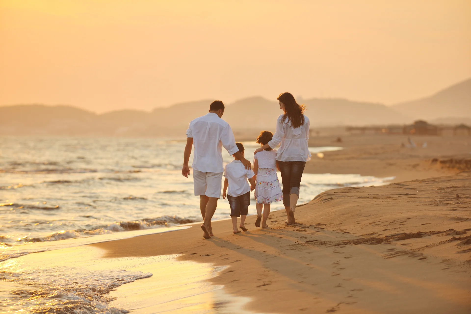 A family walking together beside the sea