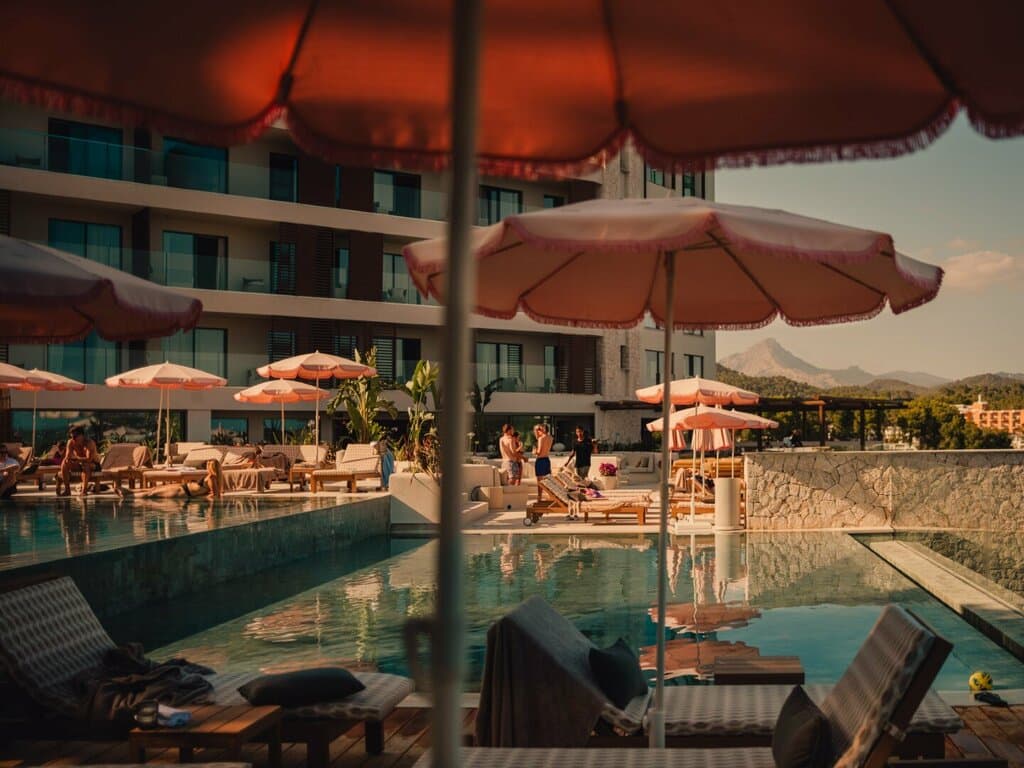 A waterfront resort pool and villa at dusk