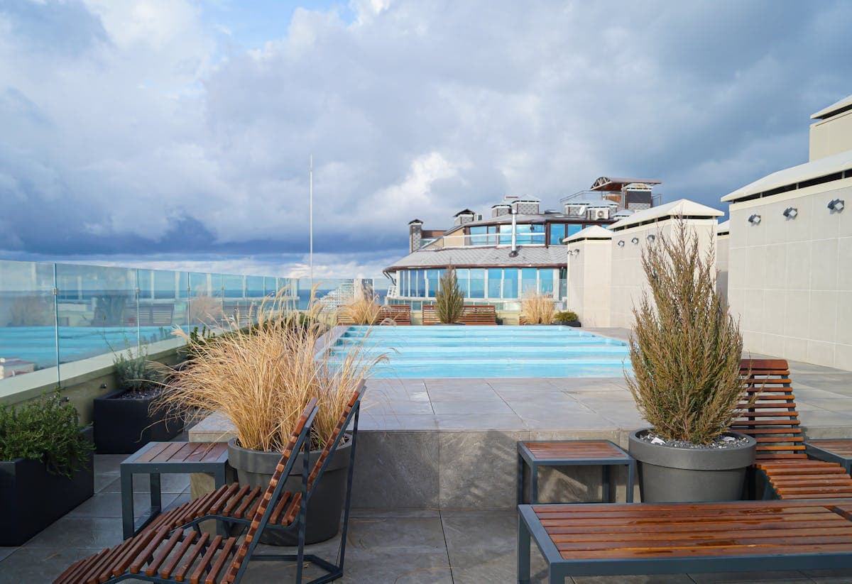 A waterfront resort pool and terrace at dusk