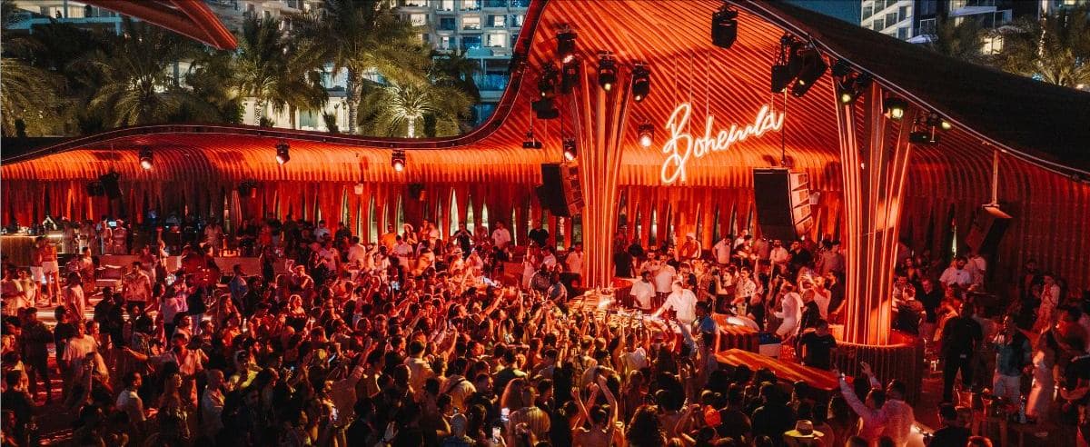 A live event production with stage lighting and an audience