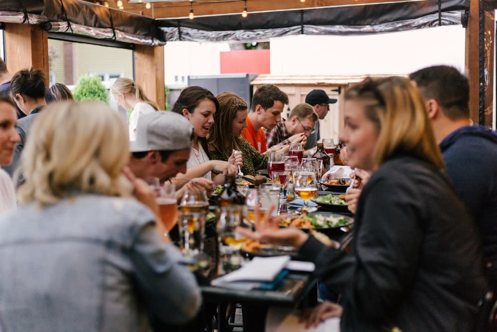 A group sharing a meal around a long table