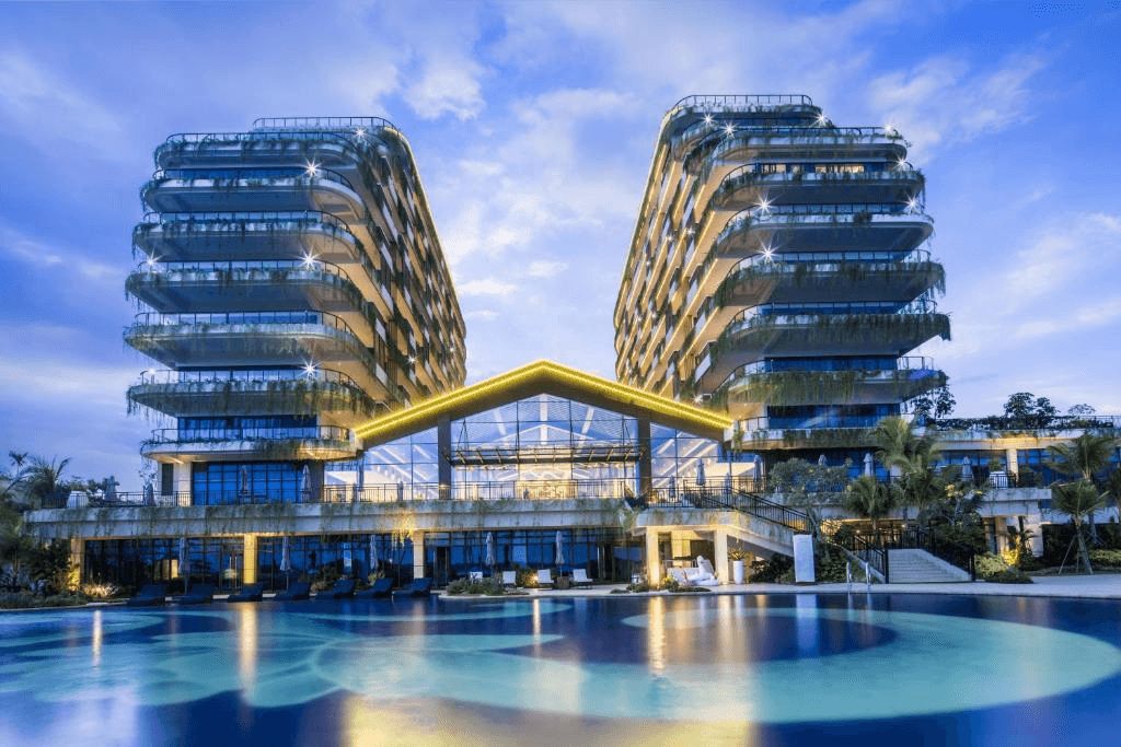 A resort building and pool illuminated at night