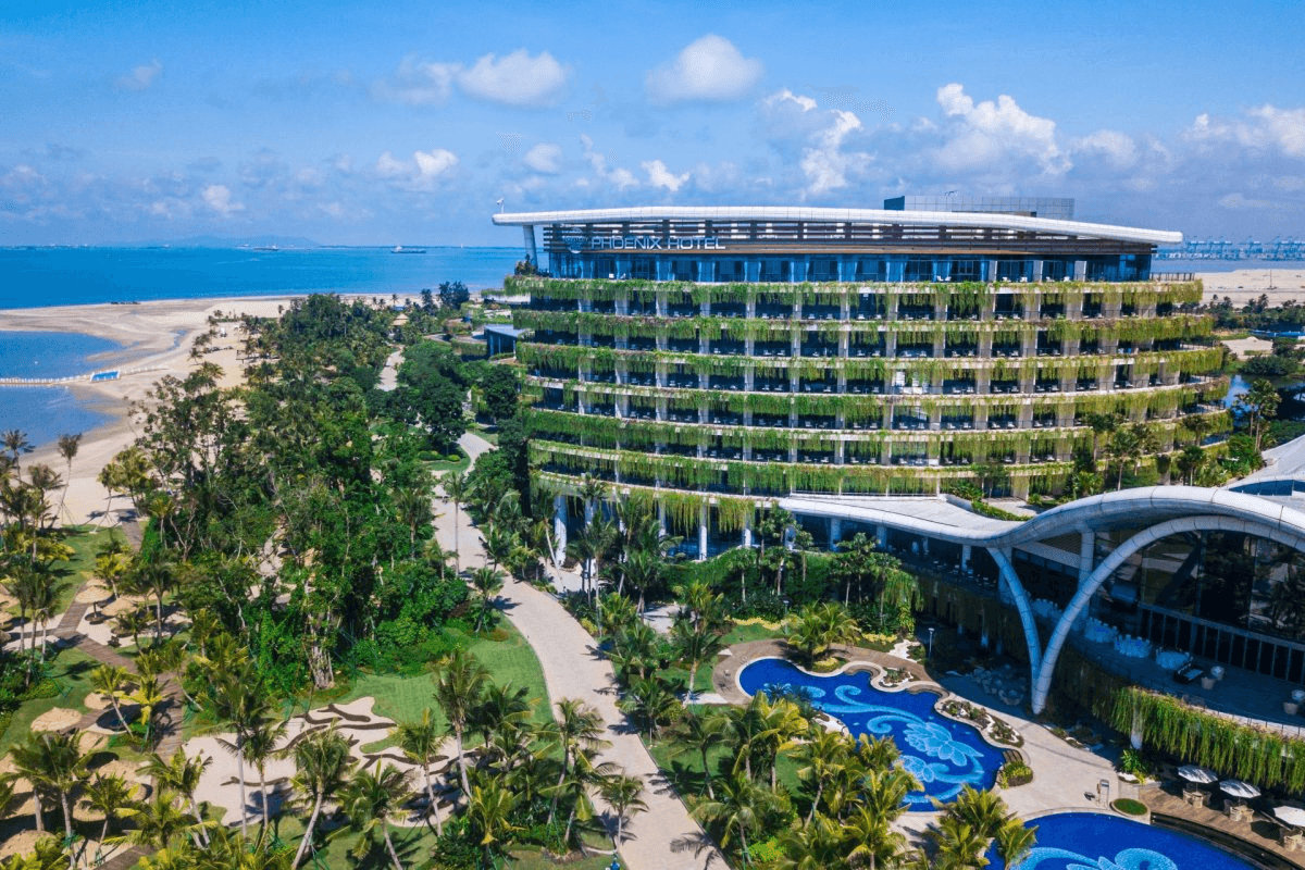 A bright waterfront resort with tropical landscaping
